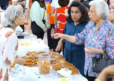 Women purchasing traditional Indian snacks from a vendor at Diwali Bazaar Jakarta by Gandhi Seva Loka.