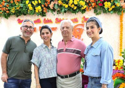Group of four posing in front of the floral photo booth at the Diwali Bazaar in Jakarta organized by Gandhi Seva Loka.
