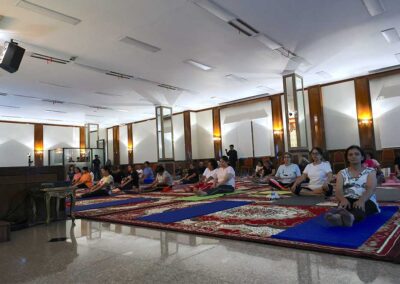 Group seated on yoga mats for warm-up at Miracle Yoga class Jakarta.