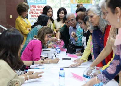 Guests registering at the reception desk during Raksha Bandhan celebration by Gandhi Seva Loka in Jakarta.