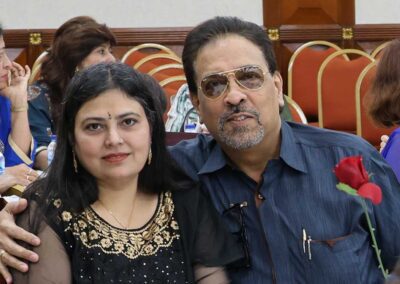 Indian Couple smiling and holding a red rose at Raksha Bandhan celebration by Gandhi Seva Loka.