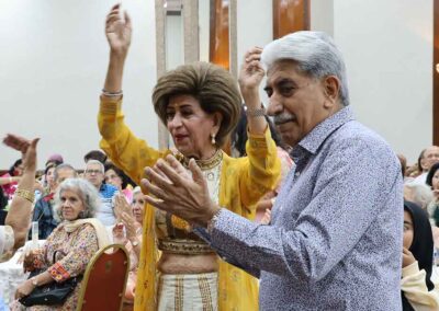 Indian couple dancing and clapping during Raksha Bandhan celebration by Gandhi Seva Loka in Jakarta.